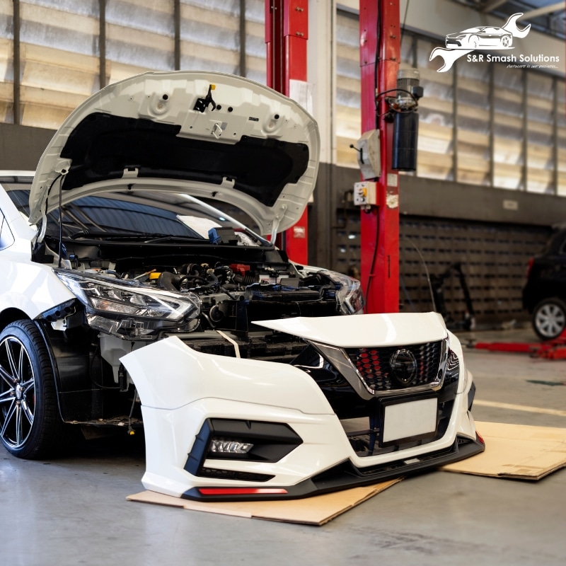 An eye-catching front bumper displayed in Abbotsbury smash repair workshop, ready for installation or repair.